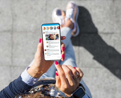 Woman using social media microblogging app on her phone