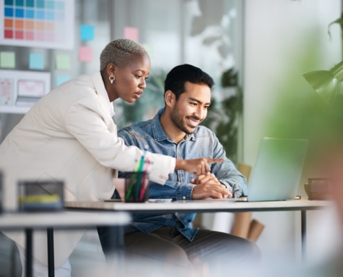 Office laptop, diversity teamwork and happy people review media application layout, creative design or research project Collaboration, designer or professional team working on app development report