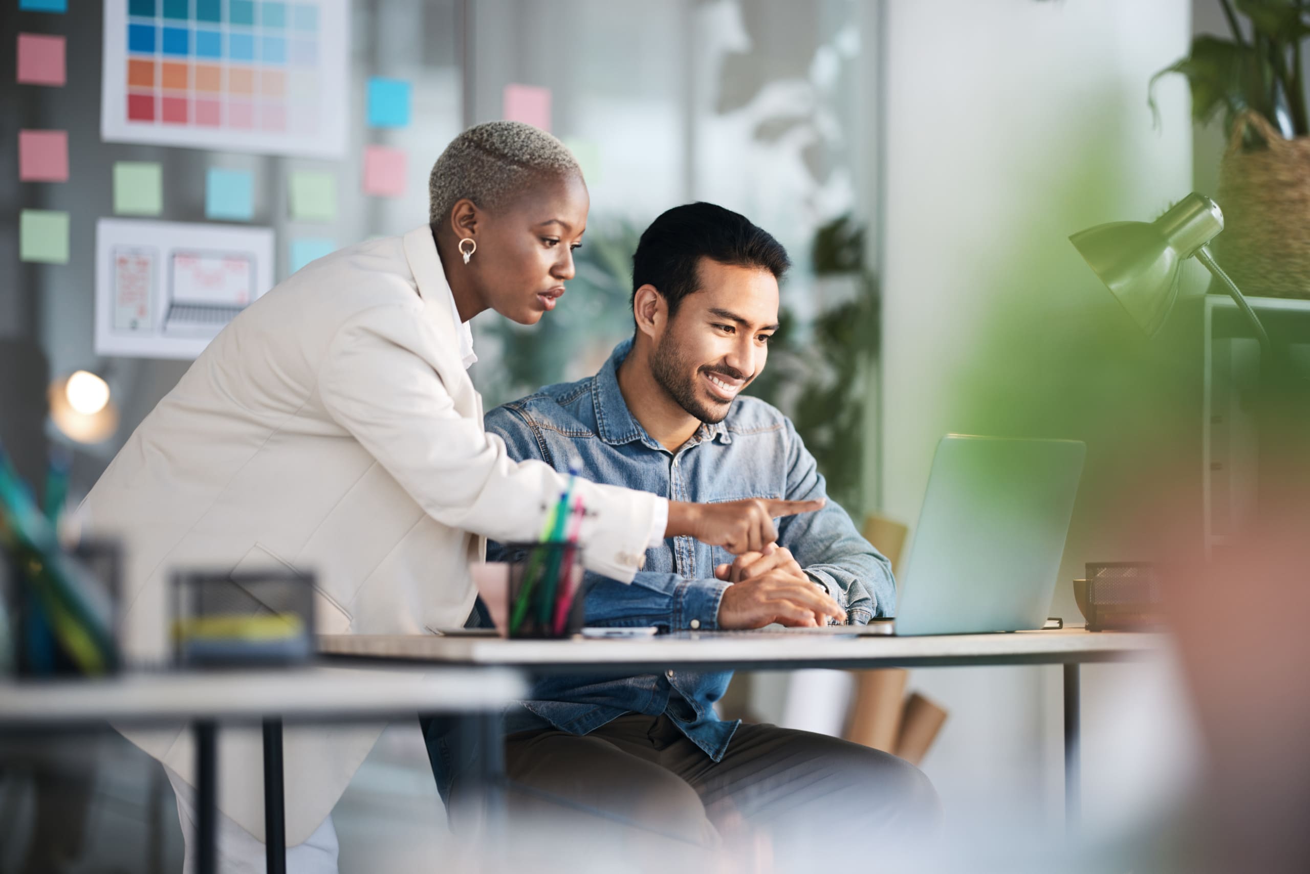 Office laptop, diversity teamwork and happy people review media application layout, creative design or research project Collaboration, designer or professional team working on app development report